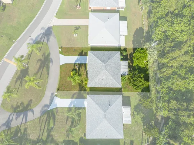 an aerial view of residential houses with outdoor space
