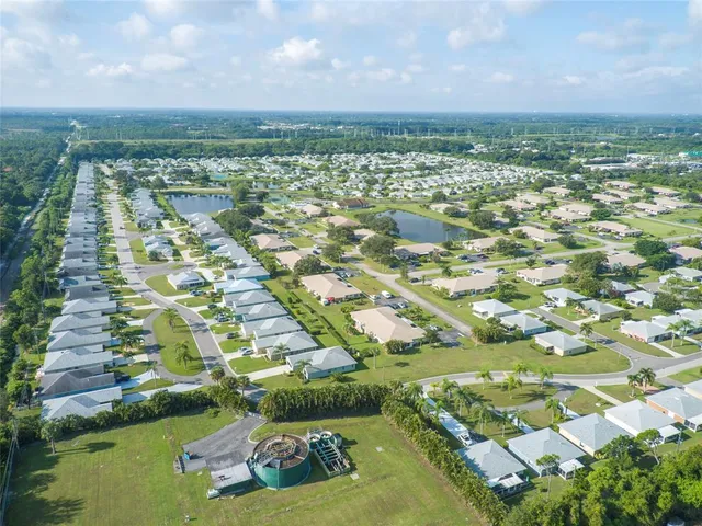 an aerial view of a house with a swimming pool outdoor seating and yard