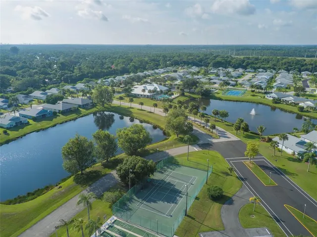 an aerial view of residential houses with outdoor space and swimming pool