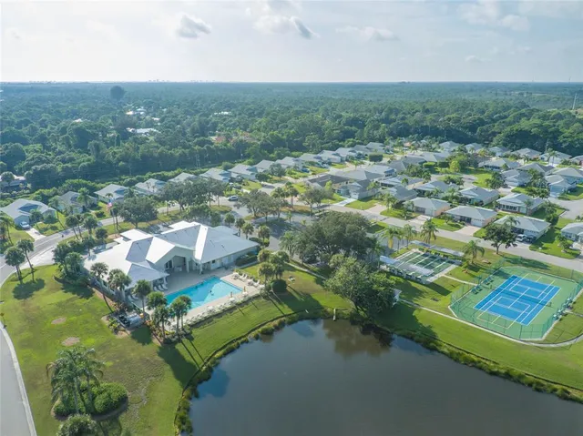 an aerial view of residential houses with outdoor space and swimming pool