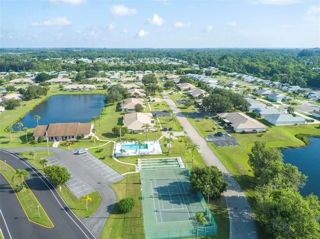 an aerial view of a city with lots of residential buildings and mountain view in back