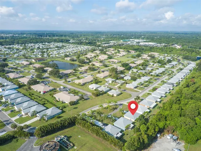 an aerial view of residential houses with outdoor space and parking
