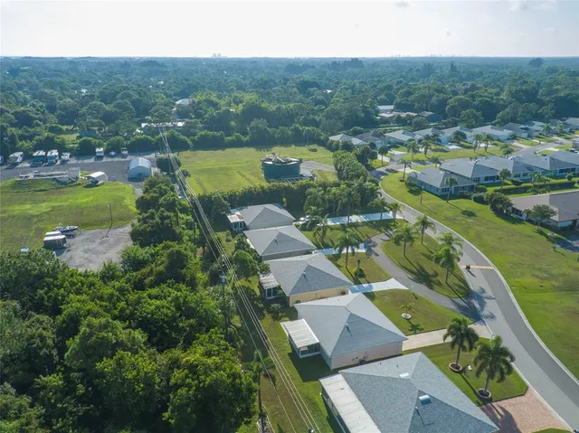 an aerial view of residential houses with outdoor space and lake view