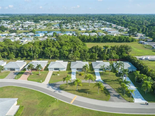 an aerial view of a house with a swimming pool yard and outdoor seating