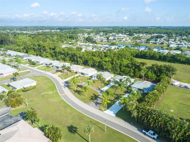 an aerial view of residential houses with outdoor space and river