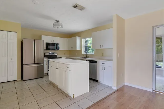 a kitchen with a refrigerator sink and microwave