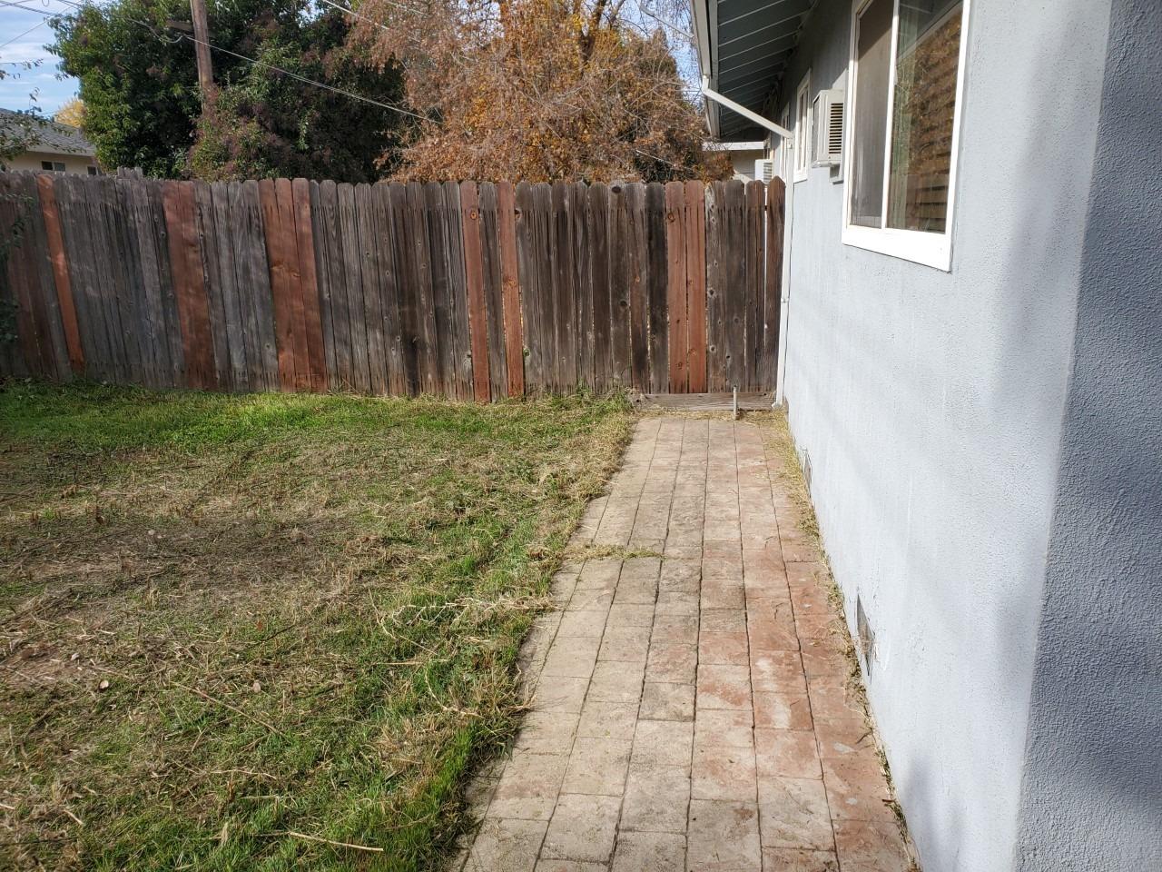 6012-6014 Bourbon Drive Carmichael, CA 95608 - Photo 18 of 30 a view of a pathway with a wooden fence
