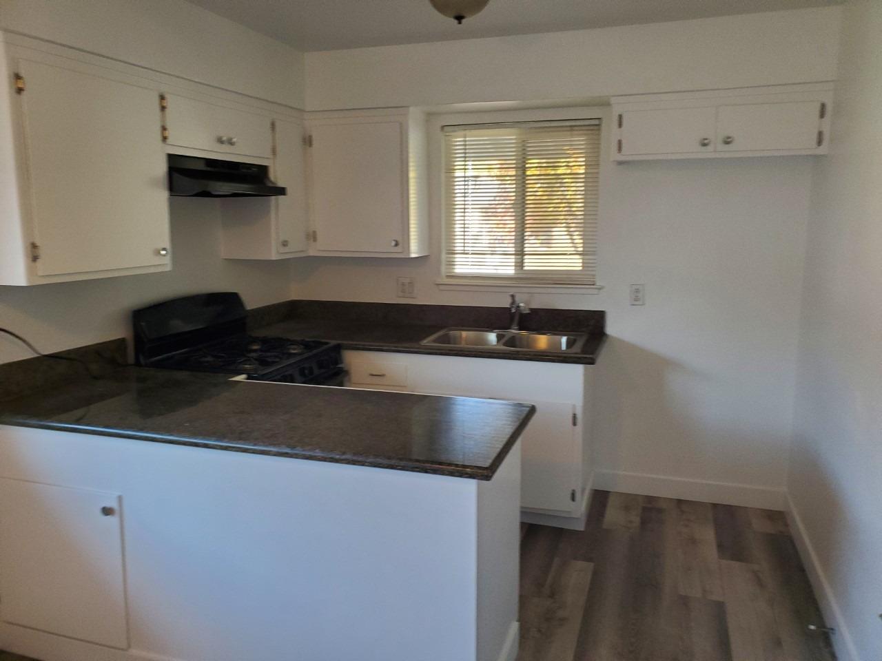 6012-6014 Bourbon Drive Carmichael, CA 95608 - Photo 30 of 30 a kitchen with granite countertop a sink and a stove