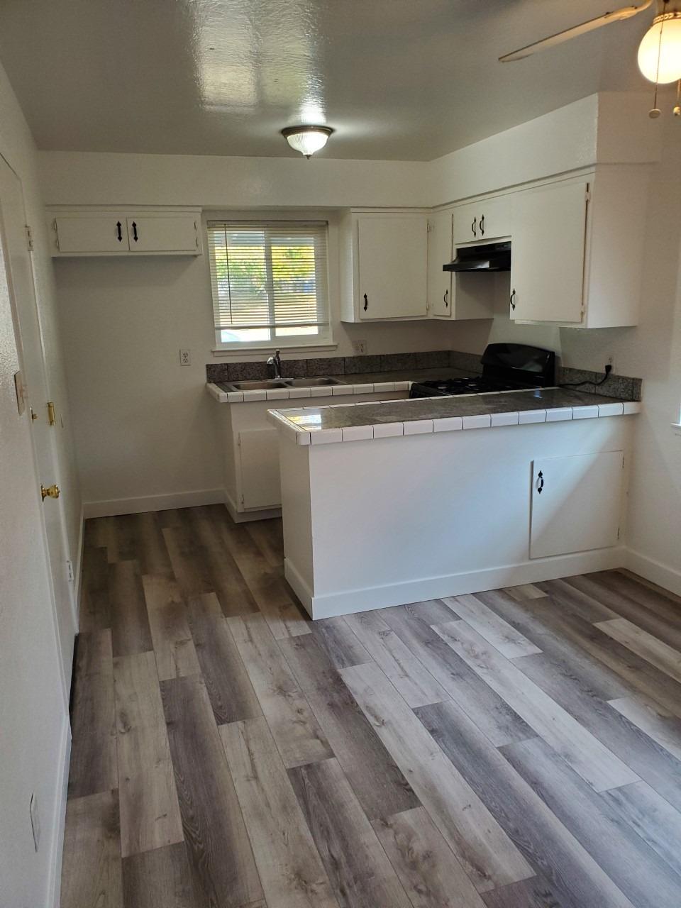 6012-6014 Bourbon Drive Carmichael, CA 95608 - Photo 5 of 30 a kitchen with a sink and cabinets