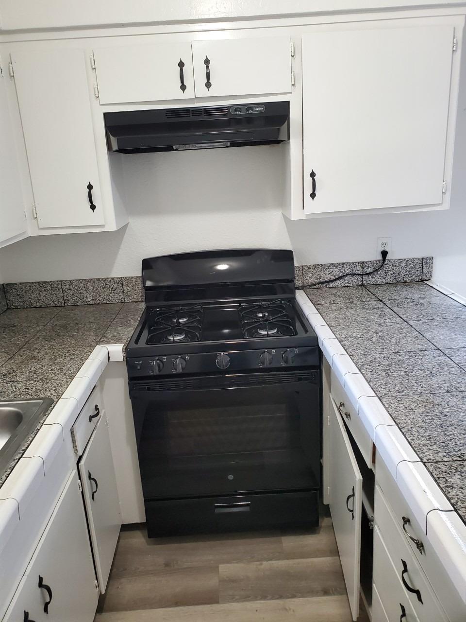 6012-6014 Bourbon Drive Carmichael, CA 95608 - Photo 6 of 30 a stove top oven sitting inside of a kitchen