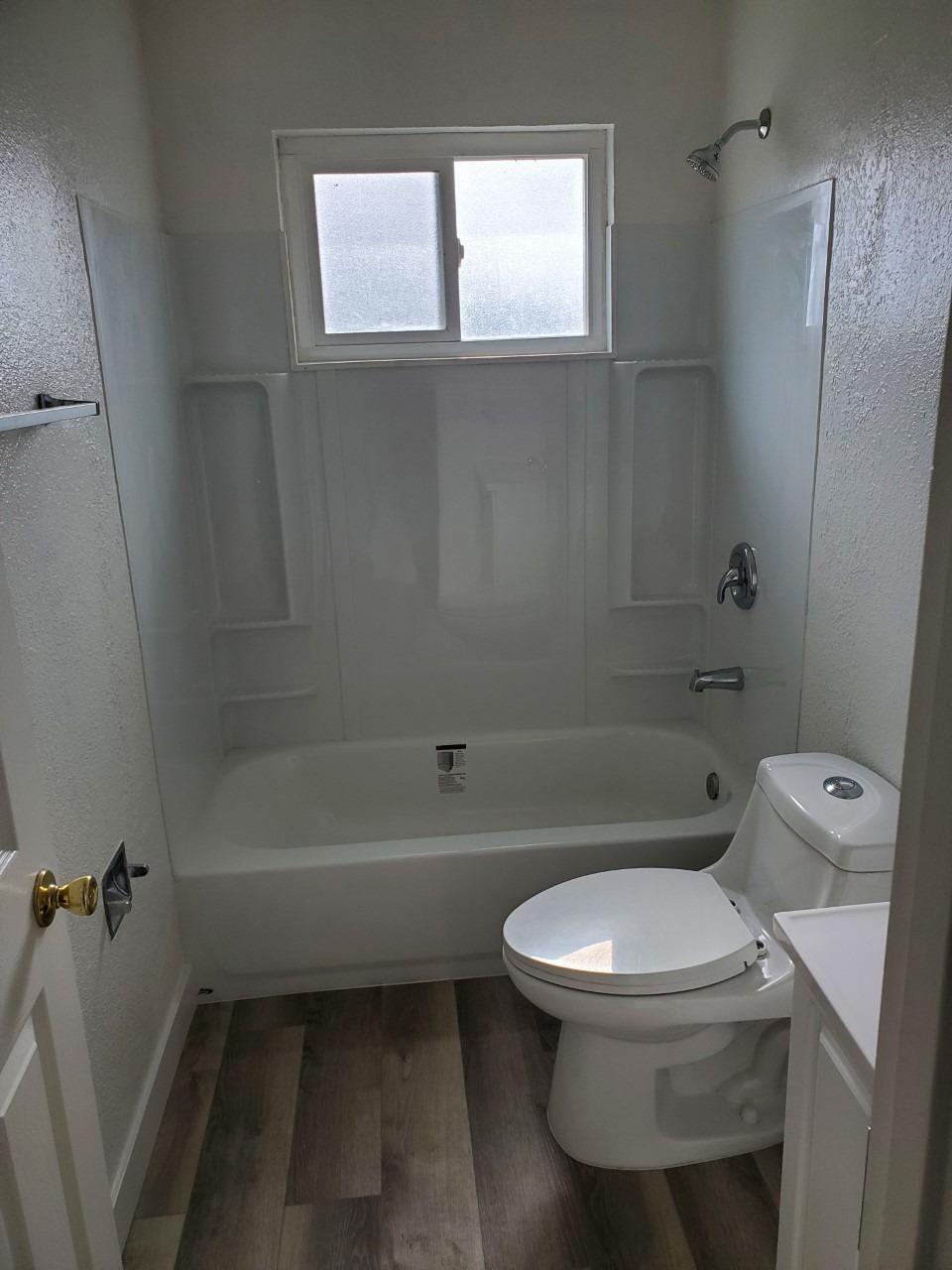 6012-6014 Bourbon Drive Carmichael, CA 95608 - Photo 10 of 30 a white toilet sitting next to a bath tub