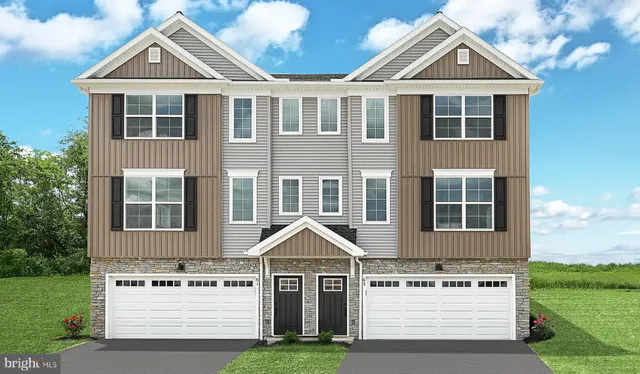 a view of a white house with a yard and potted plants