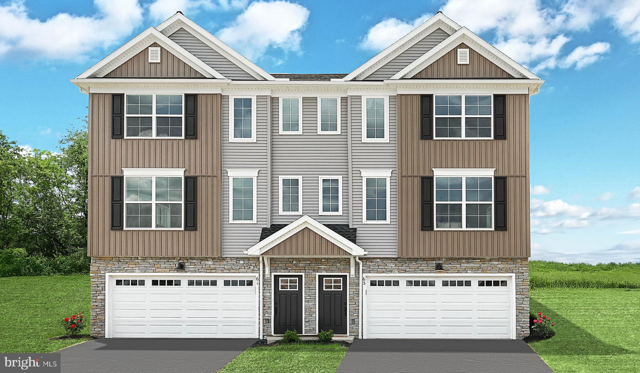 a view of a white house with a yard and potted plants