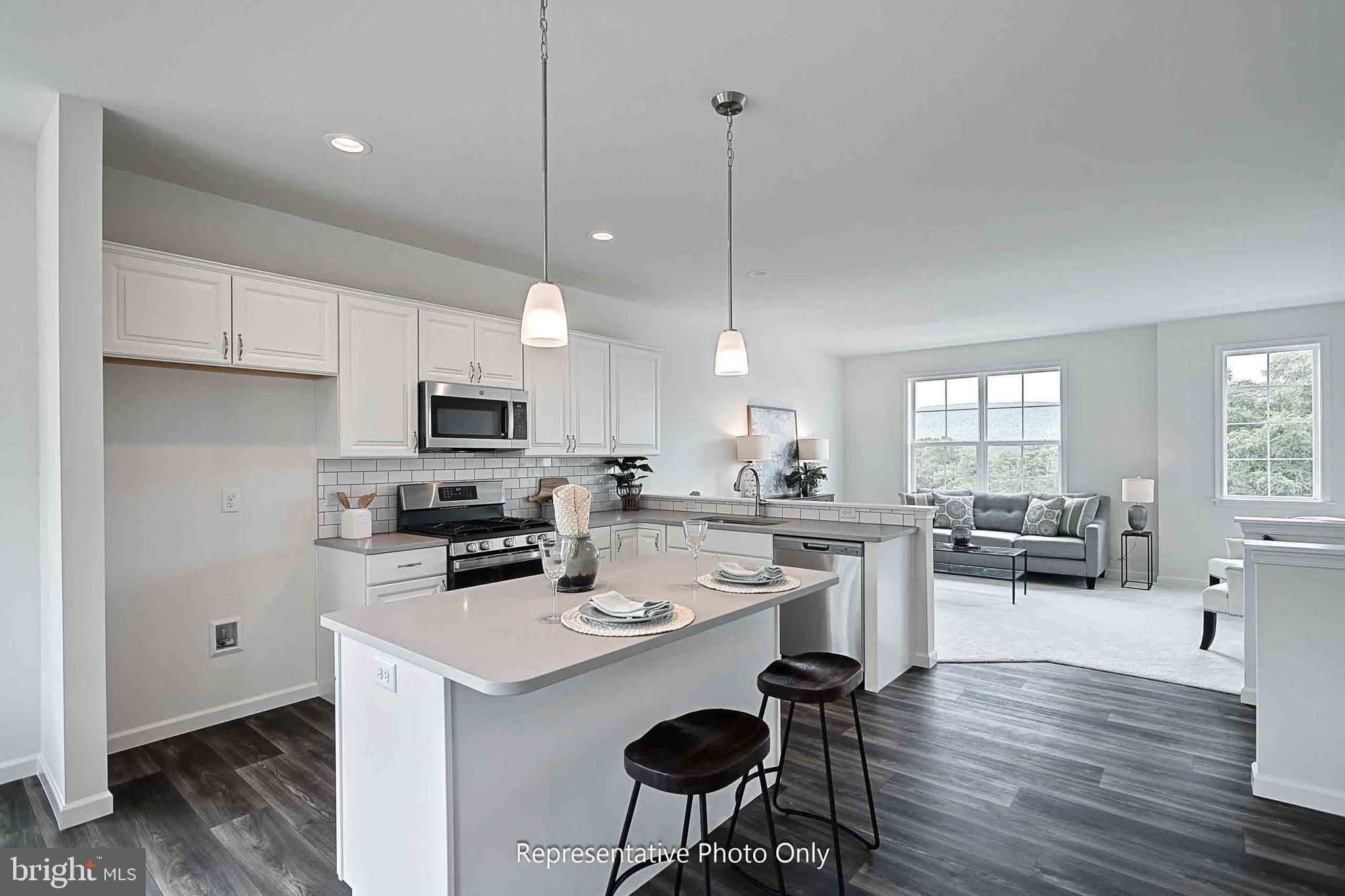 61 Glenn View Carlisle, PA 17013 - Photo 8 of 28 a kitchen with a sink a stove a refrigerator and white cabinets with wooden floor