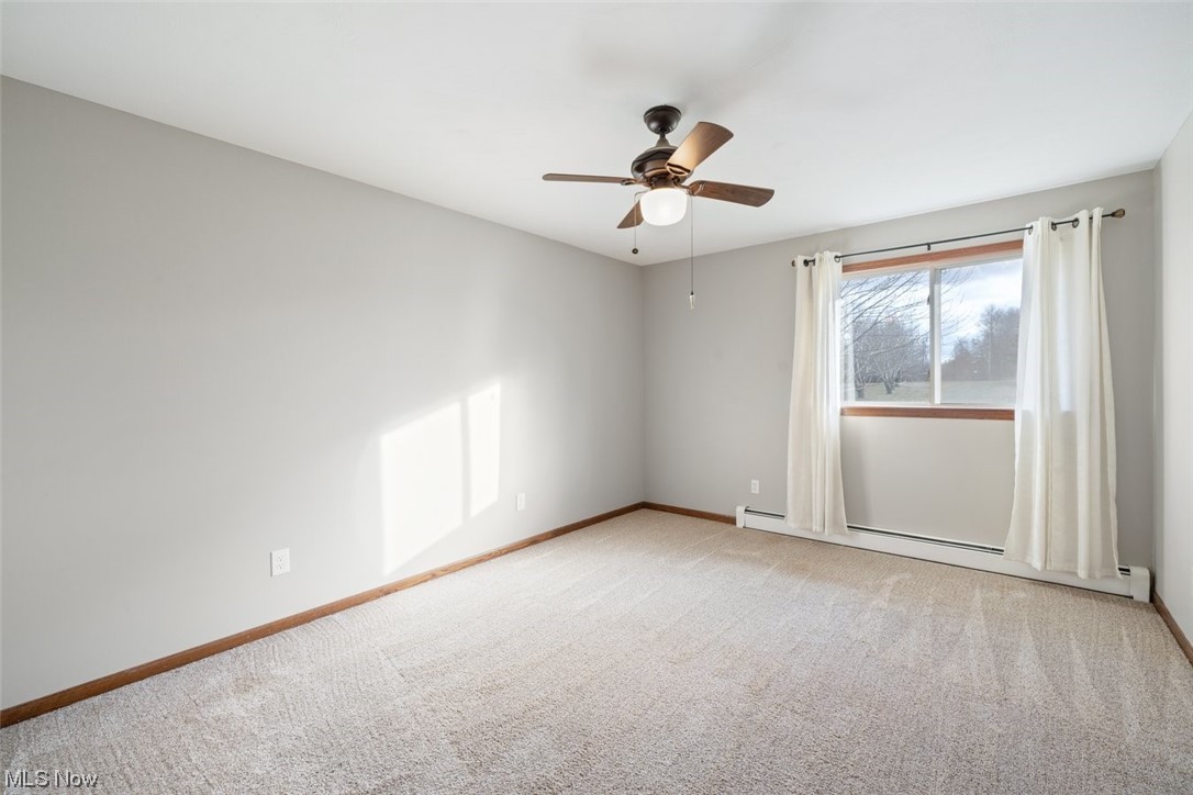 8221 Stone Road Medina, OH 44256 - Photo 18 of 35 Carpeted bedroom featuring ceiling fan and a baseboard heating unit