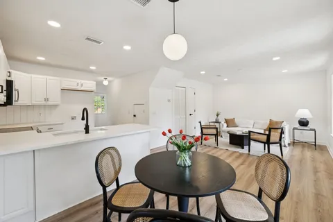 a kitchen with furniture and wooden floor
