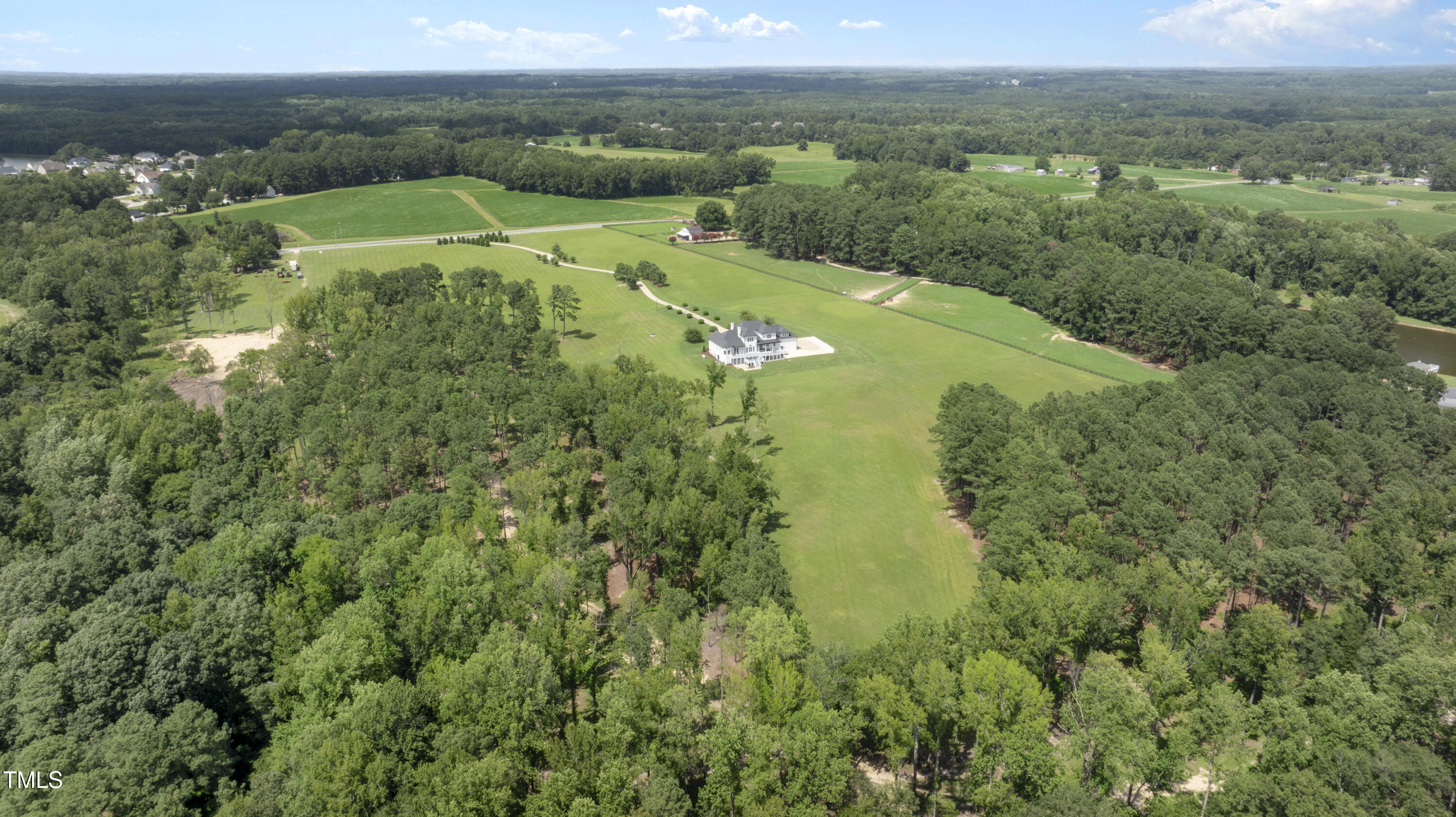 9816 Debnam Road Zebulon, NC 27597 - Photo 4 of 10 an aerial view of residential houses with outdoor space and trees