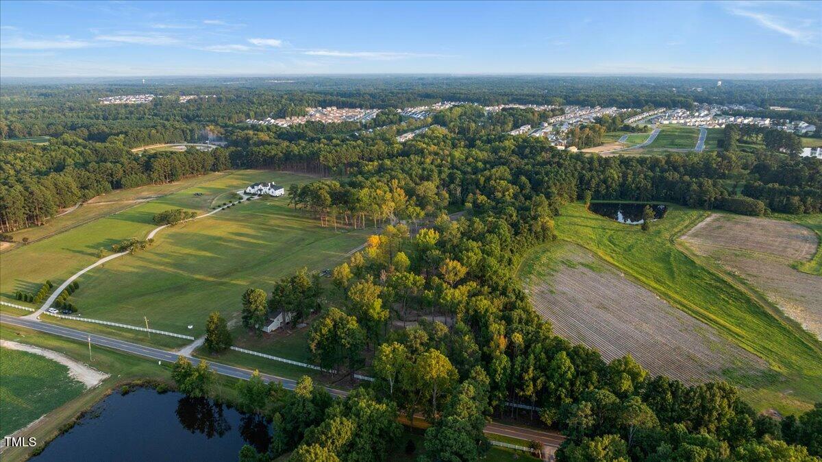 9816 Debnam Road Zebulon, NC 27597 - Photo 7 of 10 an aerial view of residential houses with outdoor space and river