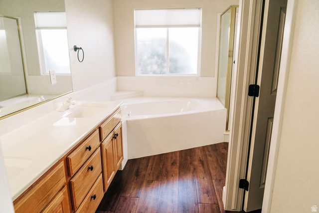 1825 West Mathis Park Place, Unit 40 St. George, UT 84770 - Photo 18 of 28 Bathroom with healthy amount of natural light, a bath, double vanity, and a stall shower