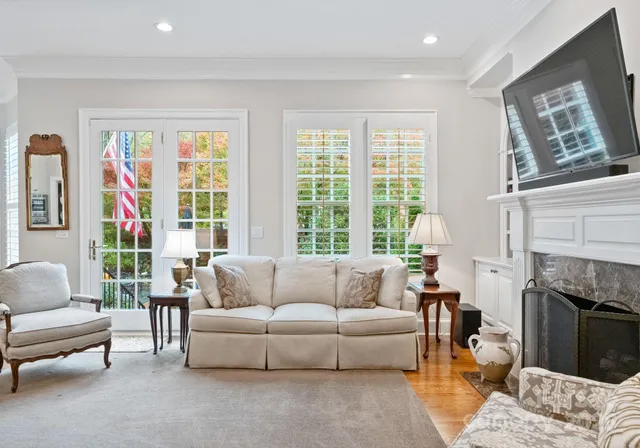 a living room with furniture and a fireplace
