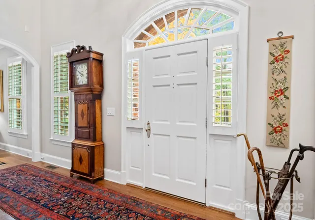 a view of an entryway with a table and chair