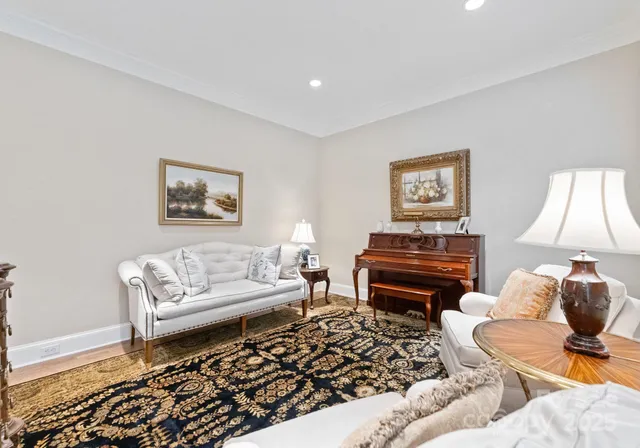 a living room with furniture a piano and a lamp