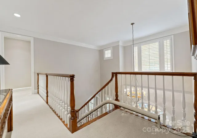 a bedroom with a bed a window and flowerpot