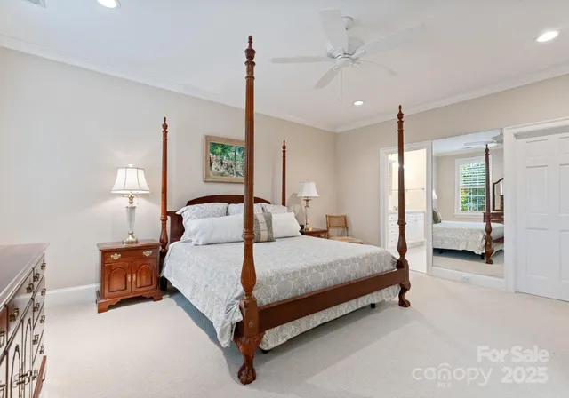 a bathroom with double vanity sinks a large mirror and a bathtub