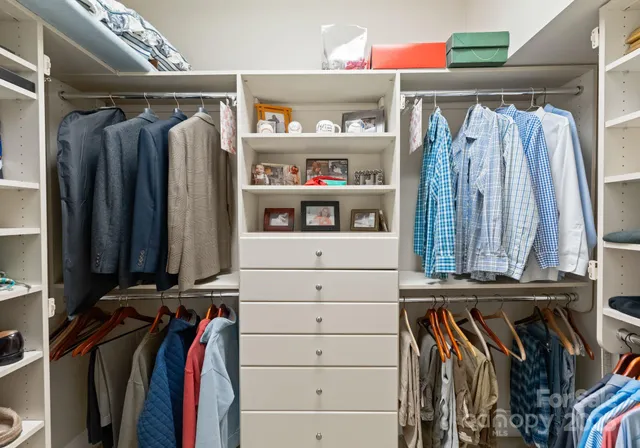 a bedroom with a bed a table and chair
