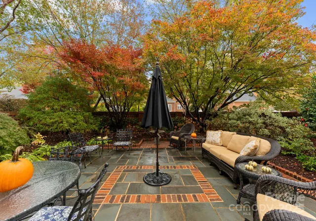 a backyard of a house with table and chairs