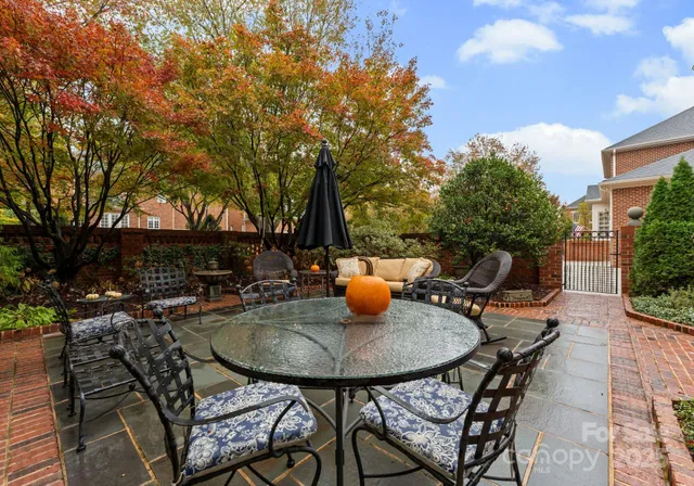 a view of a patio with couches table and chairs and potted plants