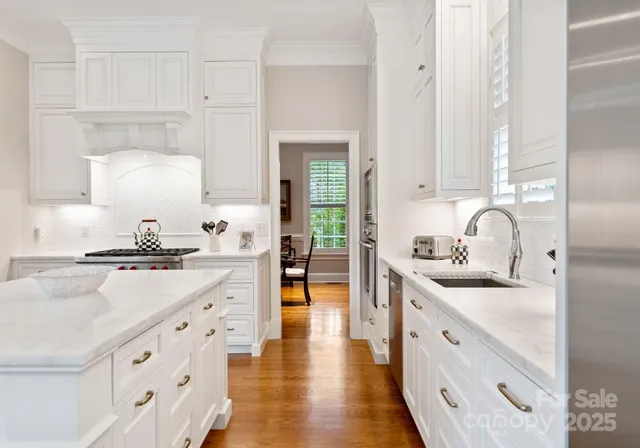 a kitchen with granite countertop a sink stove and cabinets