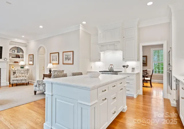 a large white kitchen with cabinets