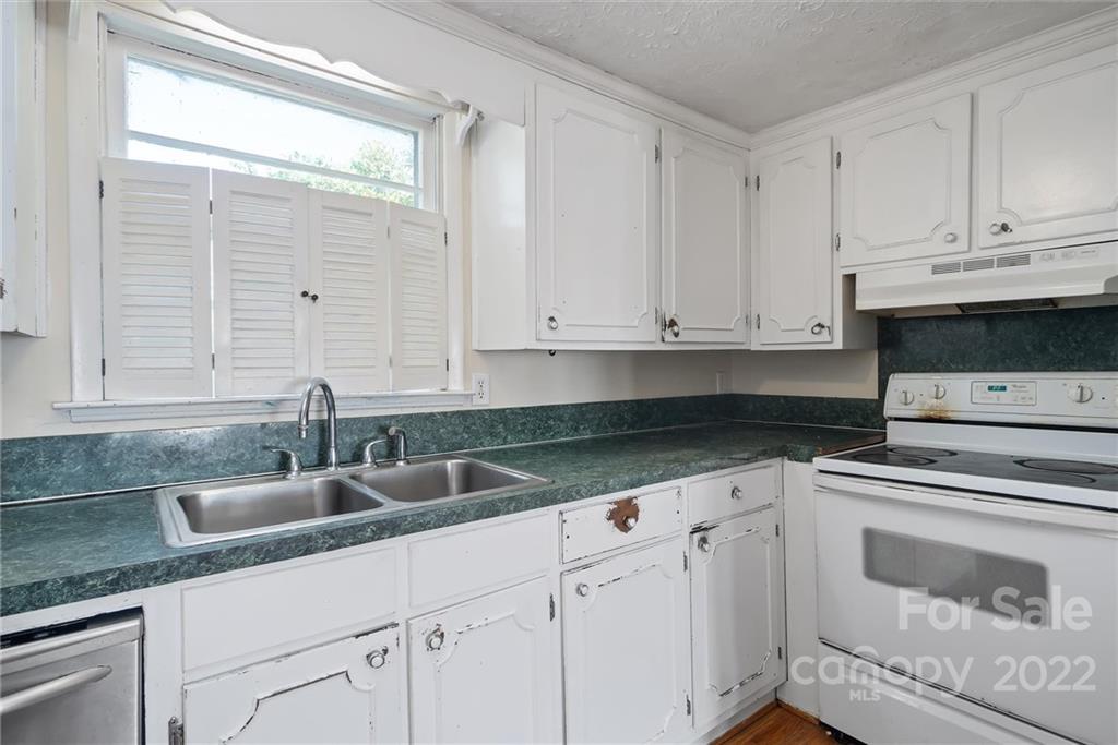 6700 Lineberger Road Sherrills Ford, NC 28673 - Photo 18 of 25 a kitchen with granite countertop white cabinets and sink