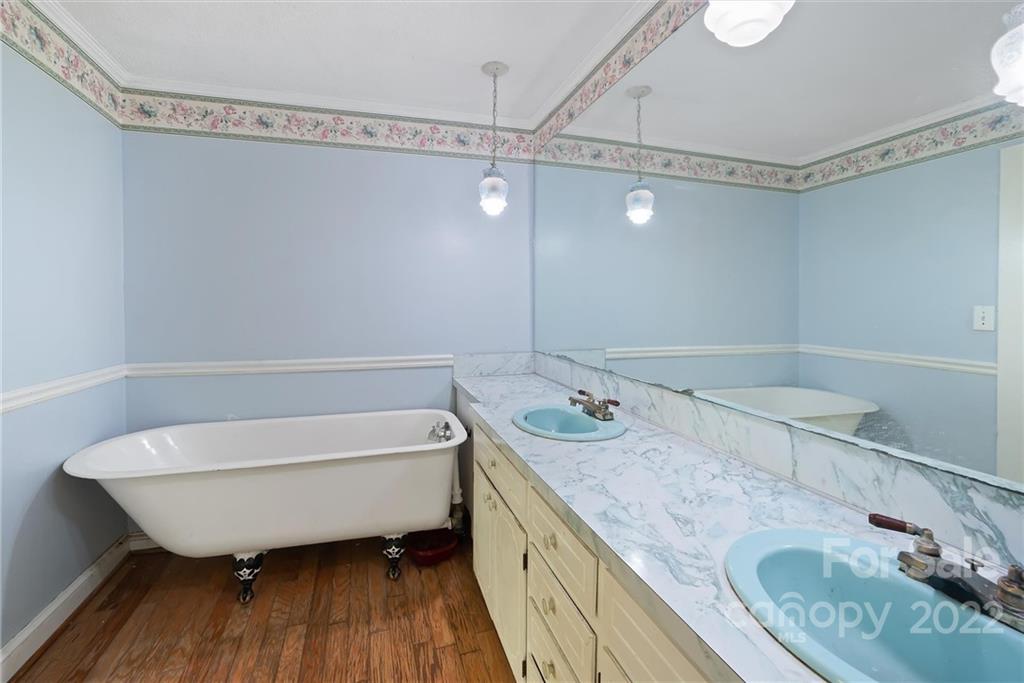 6700 Lineberger Road Sherrills Ford, NC 28673 - Photo 21 of 25 a bathroom with a granite countertop sink a mirror and bathtub