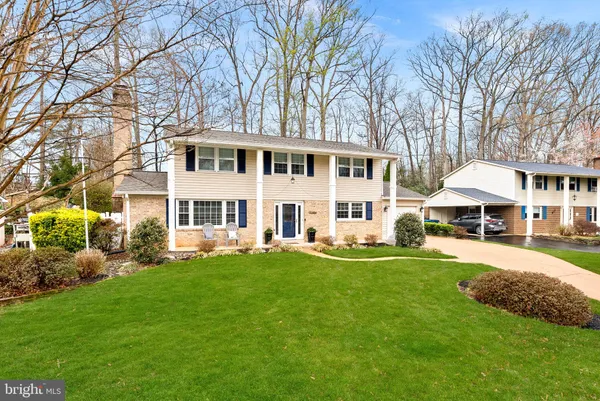 a view of a house with a yard deck and sitting area