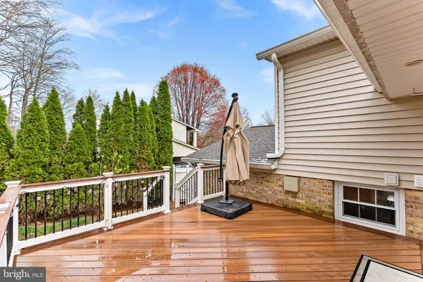 a view of a house with a yard and wooden fence