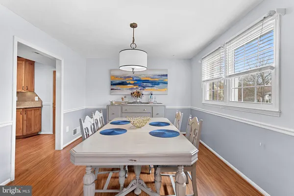 a open kitchen with stainless steel appliances granite countertop a stove and a wooden floors