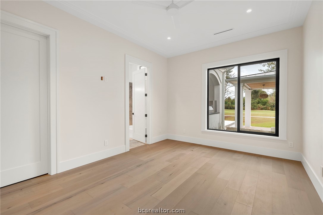4212 Tuscany Court Bryan, TX 77802 - Photo 25 of 41 an empty room with wooden floor and windows