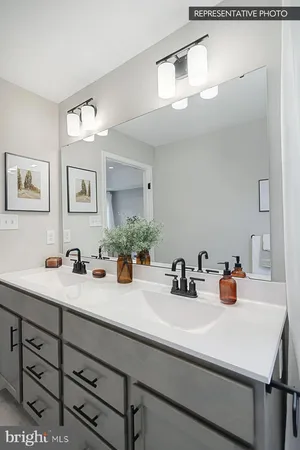a bathroom with a sink double vanity and a mirror