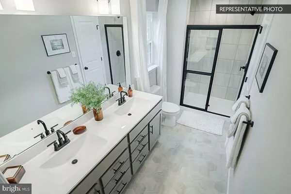 a bathroom with double vanity sink and a mirror