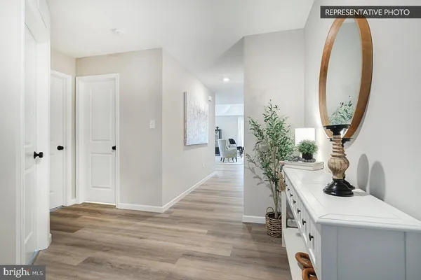 a view of a hallway with workspace and entryway