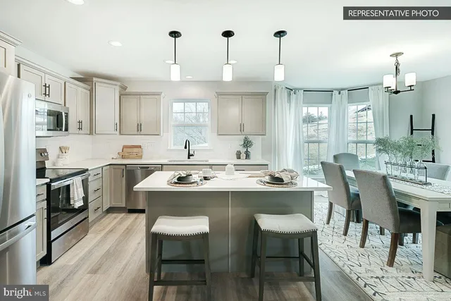 a kitchen with a sink and chairs