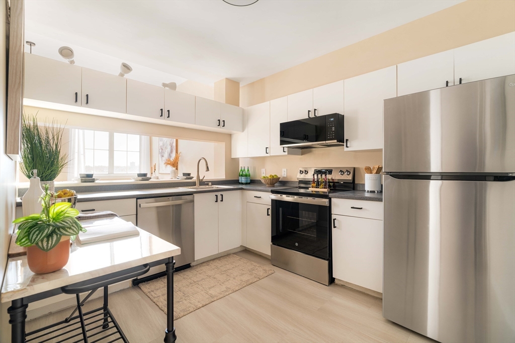 240 Heath Street, Unit PH16 Boston, MA 02130 - Photo 11 of 31 a kitchen with a refrigerator and a stove top oven