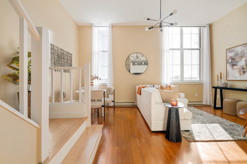 240 Heath Street, Unit PH16 Boston, MA 02130 - Photo 15 of 31 a living room with furniture a large window with wooden floor