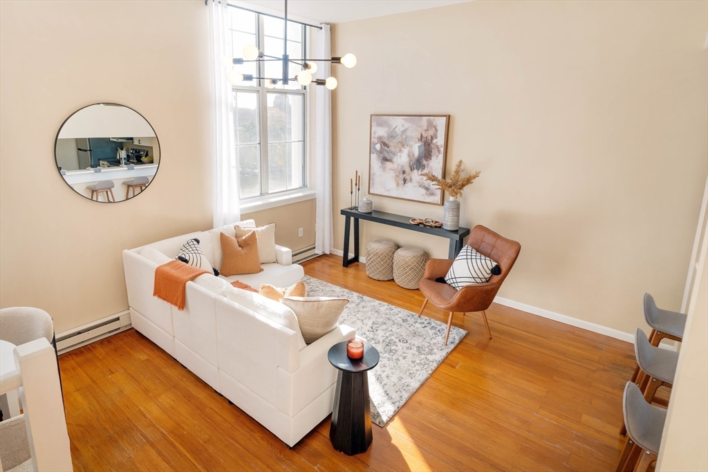 240 Heath Street, Unit PH16 Boston, MA 02130 - Photo 16 of 31 a living room with furniture and a window