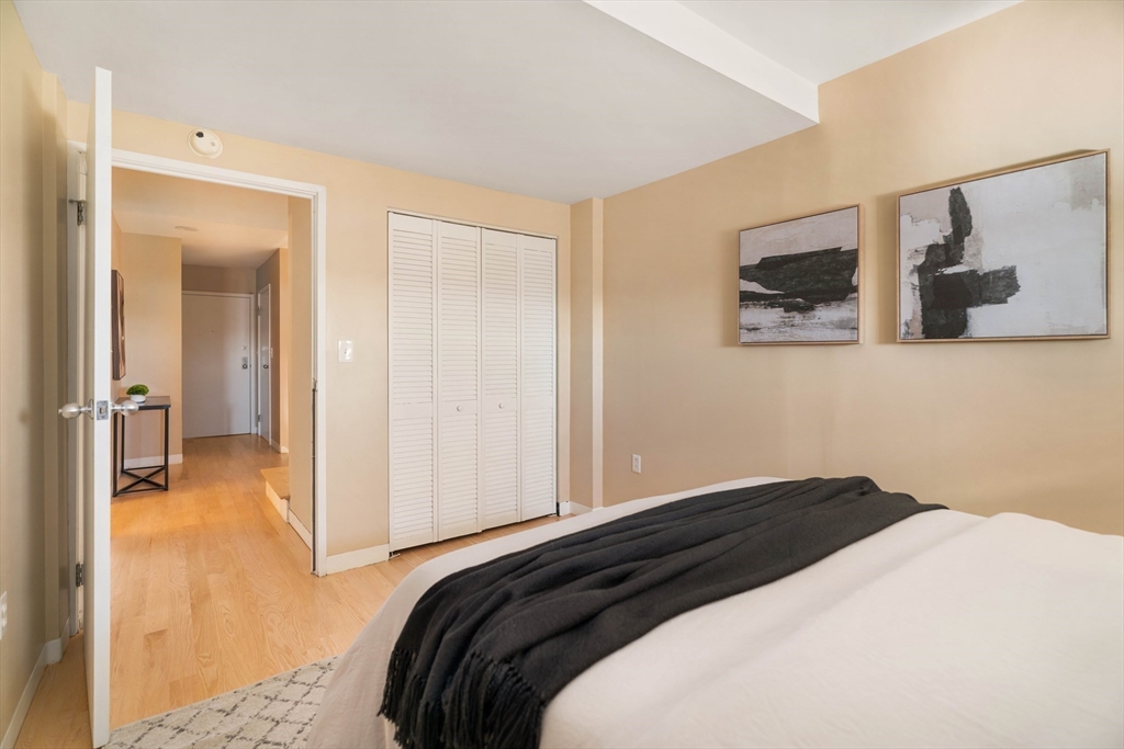 240 Heath Street, Unit PH16 Boston, MA 02130 - Photo 19 of 31 a bedroom with a bed and wall painting