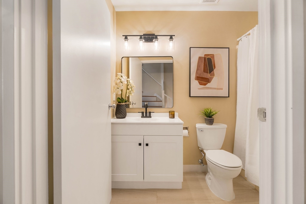 240 Heath Street, Unit PH16 Boston, MA 02130 - Photo 20 of 31 a bathroom with a toilet a sink and mirror