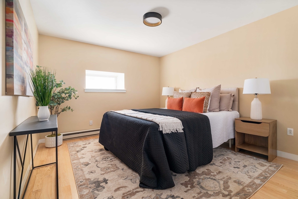 240 Heath Street, Unit PH16 Boston, MA 02130 - Photo 22 of 31 a bedroom with a bed and a potted plant