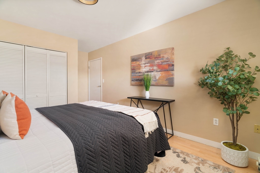 240 Heath Street, Unit PH16 Boston, MA 02130 - Photo 23 of 31 a bedroom with a bed and a potted plant